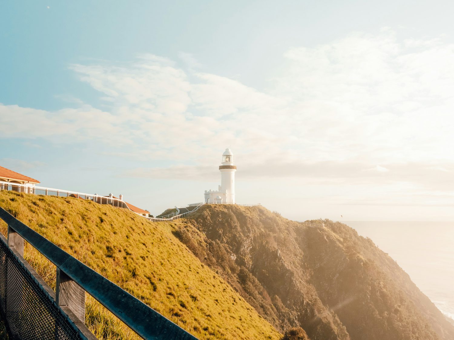 Cape Byron lighthouse above a golden headland at sunrise, Northern Rivers NSW